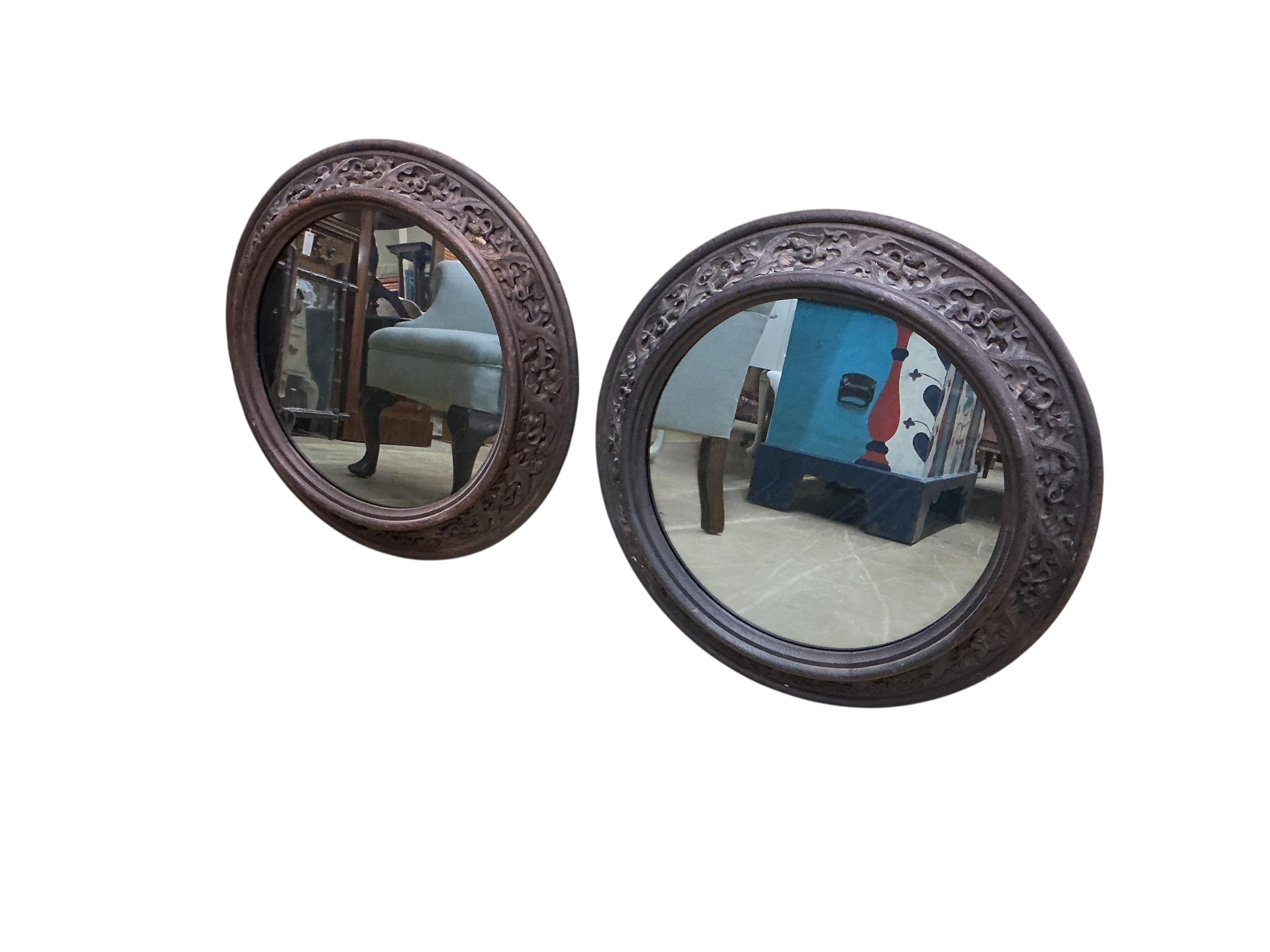 A pair of Victorian circular carved oak wall mirrors, with leaf and acorn borders, diameter 60cm